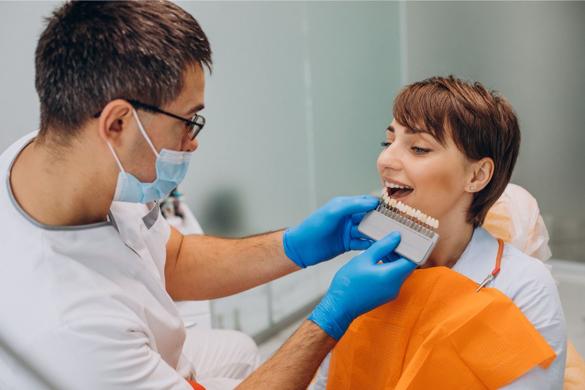Dentist examining veneers Dentist examining veneers for decay, emphasizing cavity prevention tips.
