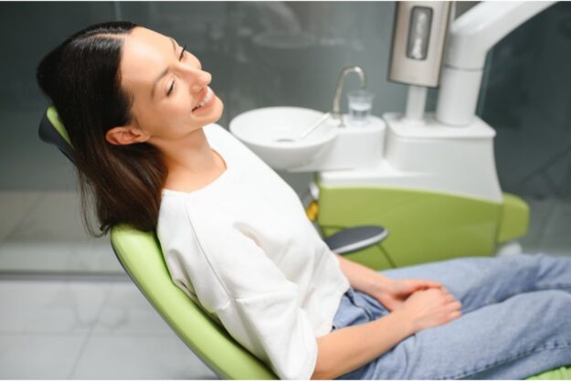 Patient smiling after successful dental implant procedure.