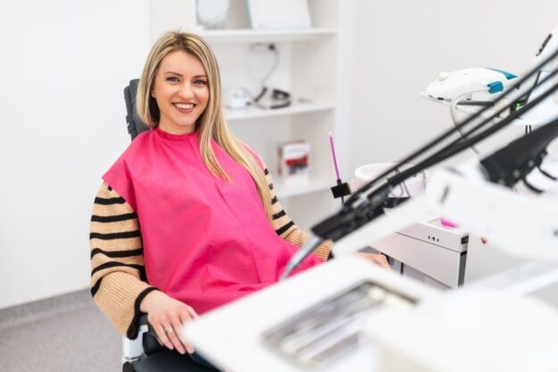 A patient smiling confidently after a professional cosmetic dental treatment.