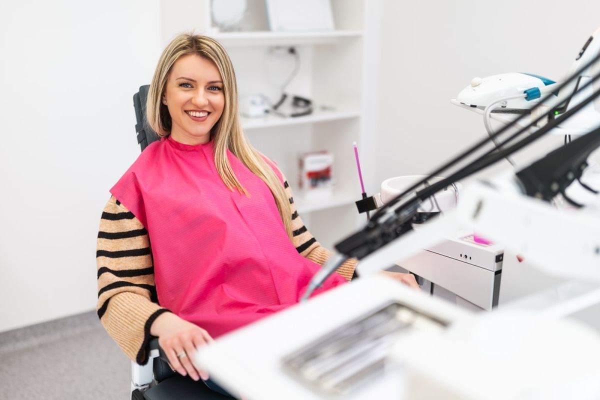 A patient smiling confidently after a professional cosmetic dental treatment.