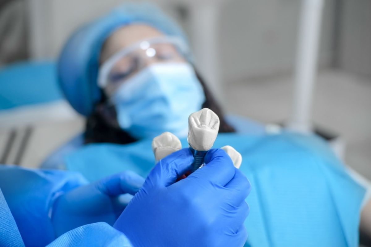 A dentist performing a dental implant procedure on a patient in a modern clinic.