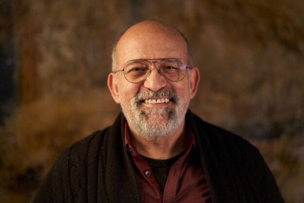 An elderly person smiling with healthy teeth after a dental check-up.