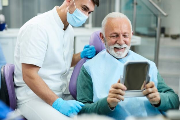 Senior man smiling after dental checkup at local clinic.