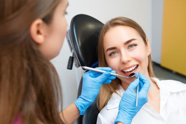 Smiling patient receiving gum care.