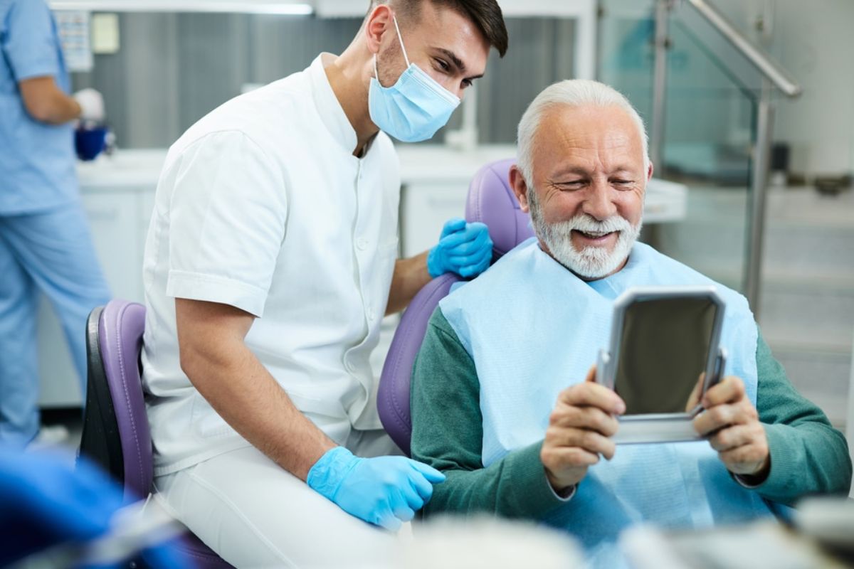 Senior man smiling confidently after receiving dental implants in Green Valley, AZ.