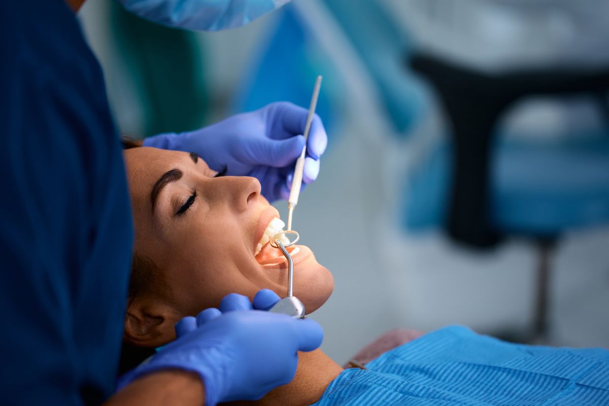 Dentist examining a patient’s teeth during a dental check-up.
