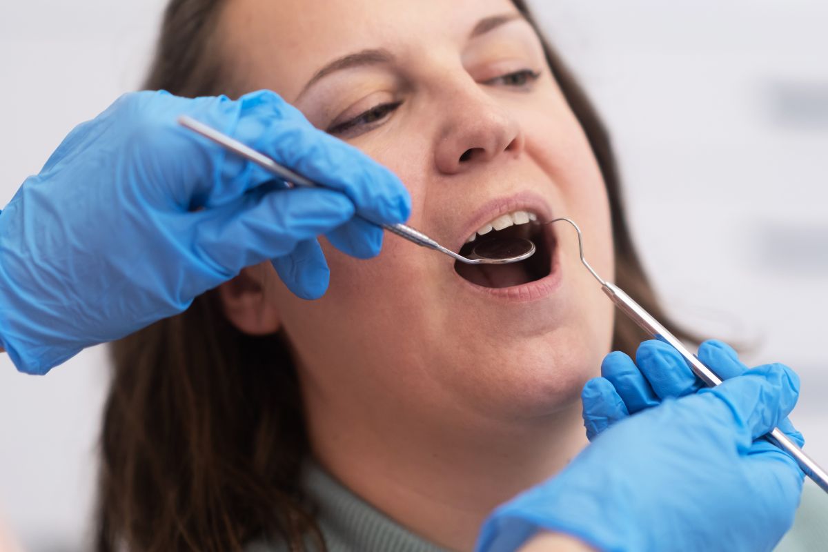 Pregnant woman receiving dental check-up from a professional dentist.
