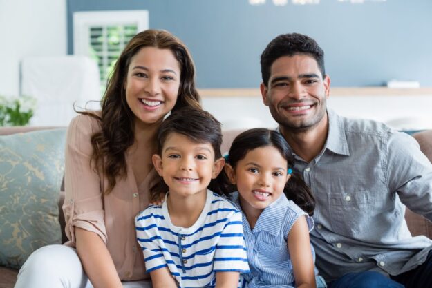 Smiling family at home enjoying the benefits of convenient care from their trusted family dentist in Green Valley.