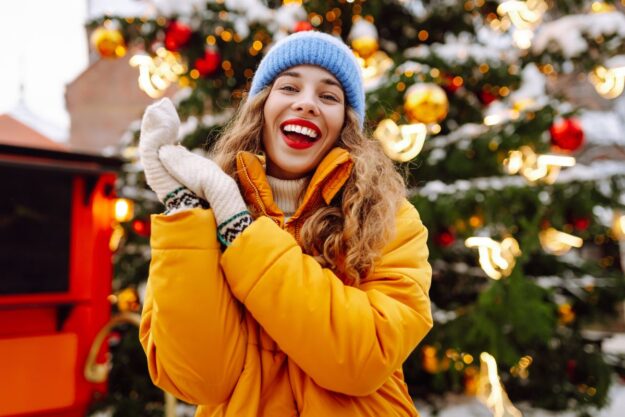A smiling person during Christmas celebrations showing a confident, festive smile with Invisalign clear aligners.