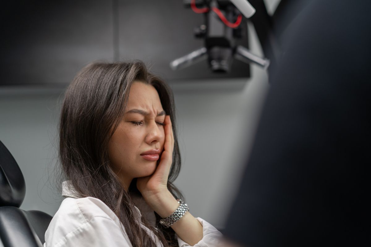 A patient experiencing sudden tooth pain requiring emergency dental care.