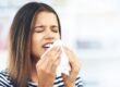 Woman experiencing seasonal allergies that may impact oral health and dental comfort.