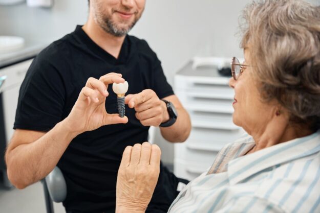 A dentist explaining dental implants to a patient.