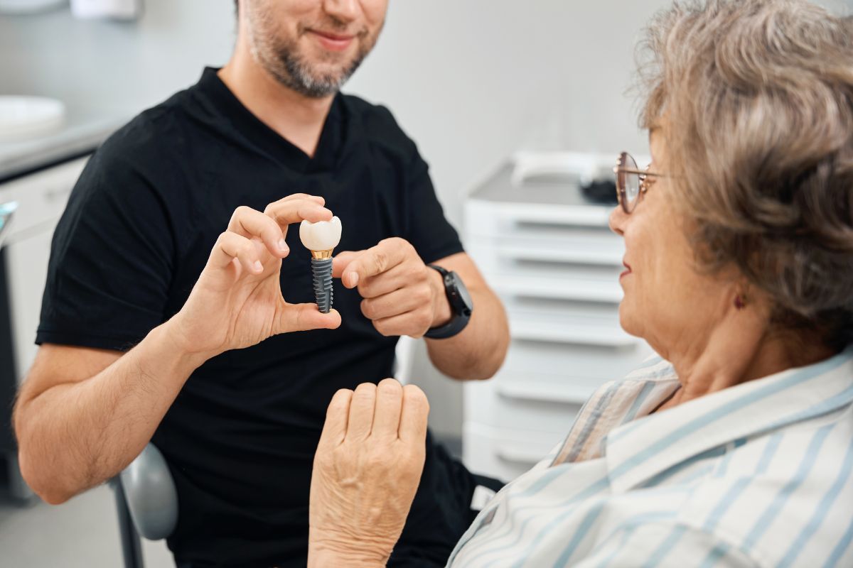 A dentist explaining dental implants to a patient.