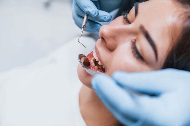 Patient feeling calm and relaxed while receiving gentle dental care at a modern dental clinic.