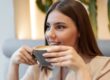 A woman enjoying coffee during Invisalign treatment while keeping aligners safe and teeth protected.