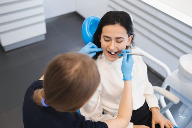 Dental Check-Up Female patient receiving a routine dental checkup at a family dental clinic for long-term oral health care.