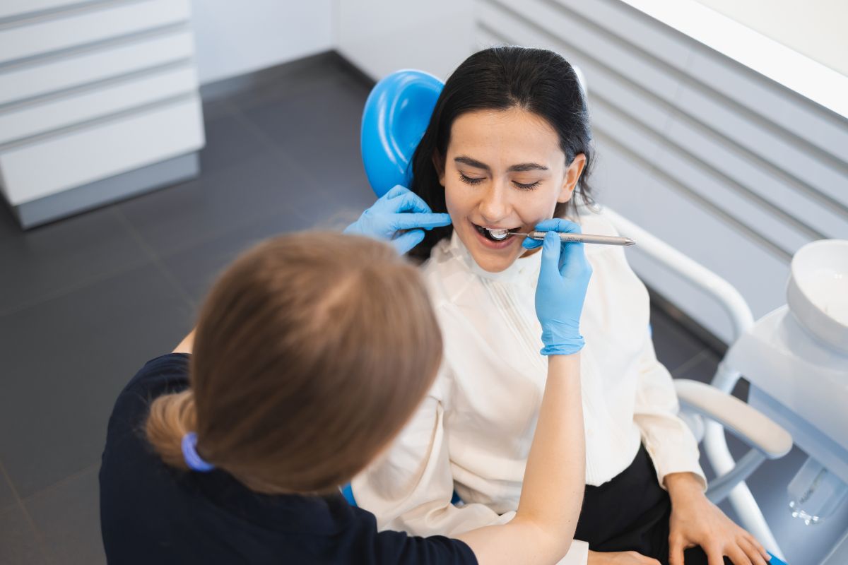 Dental Check-Up Female patient receiving a routine dental checkup at a family dental clinic for long-term oral health care.